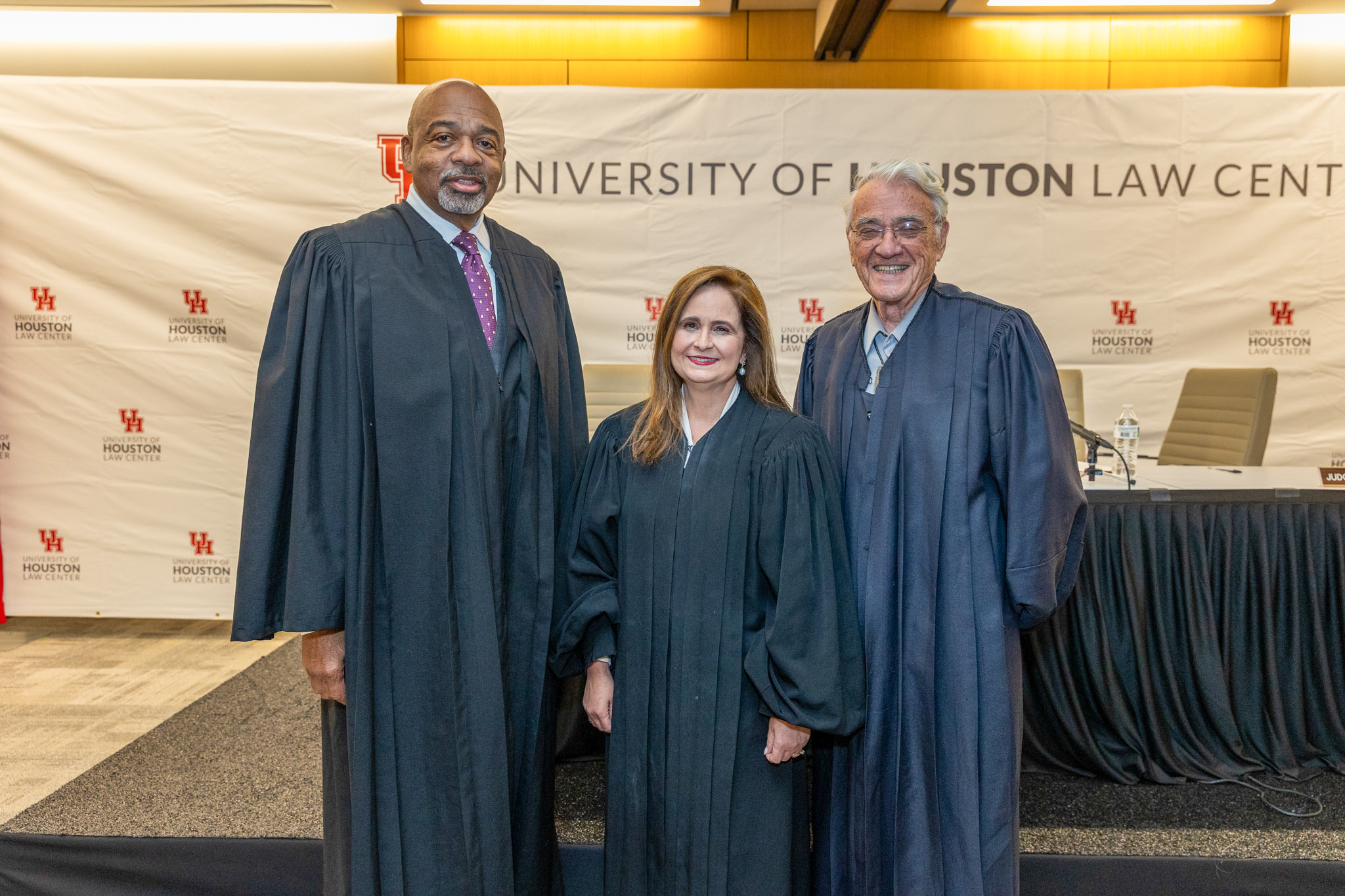 Judge James E. Graves Jr., Chief Judge Jennifer Walker Elrod, and Judge Patrick E. Higginbotham in judicial robes at the University of Houston Law Center before holding court.